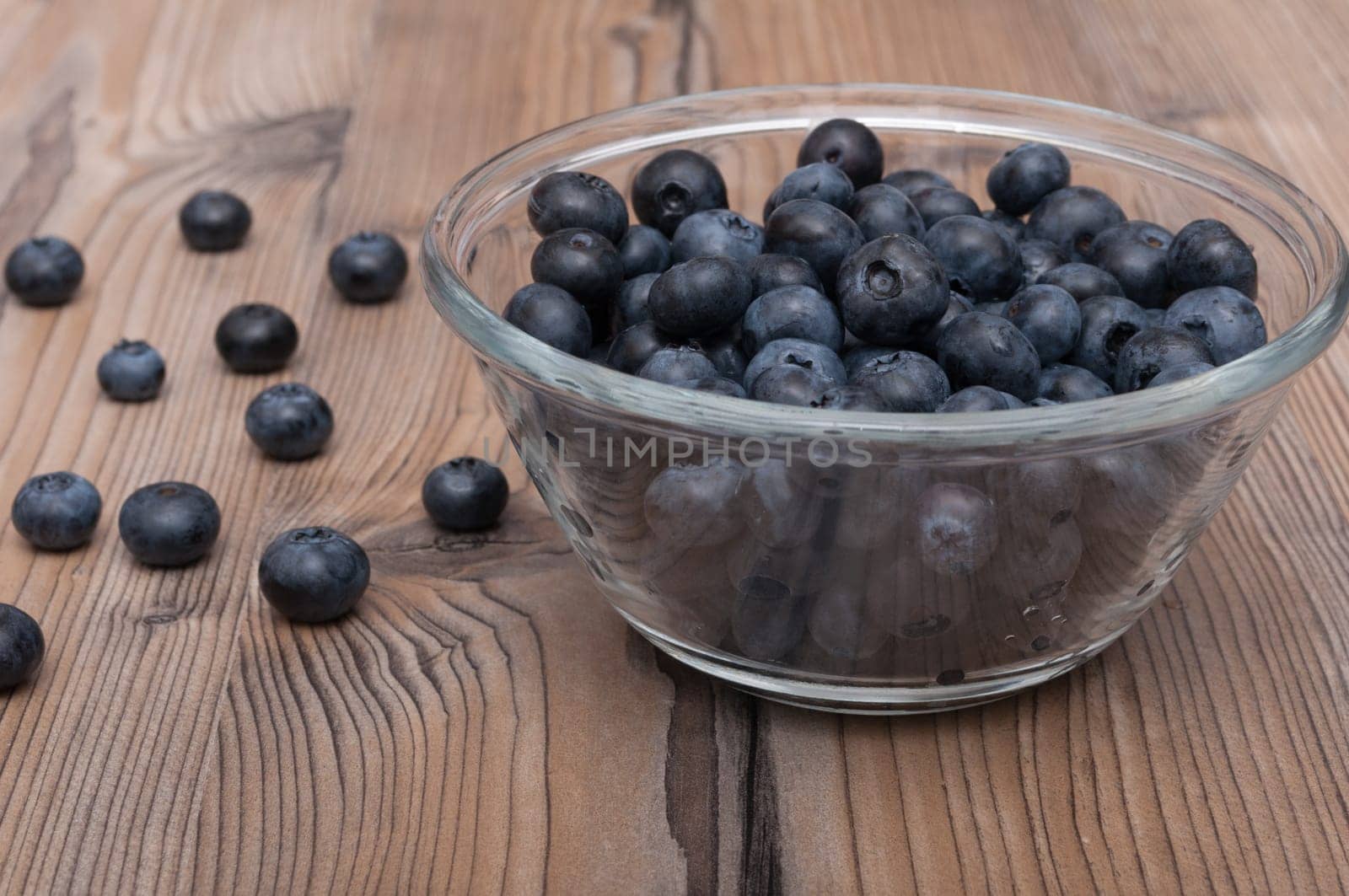 Glass Bowl of Blueberries on Wooden Table