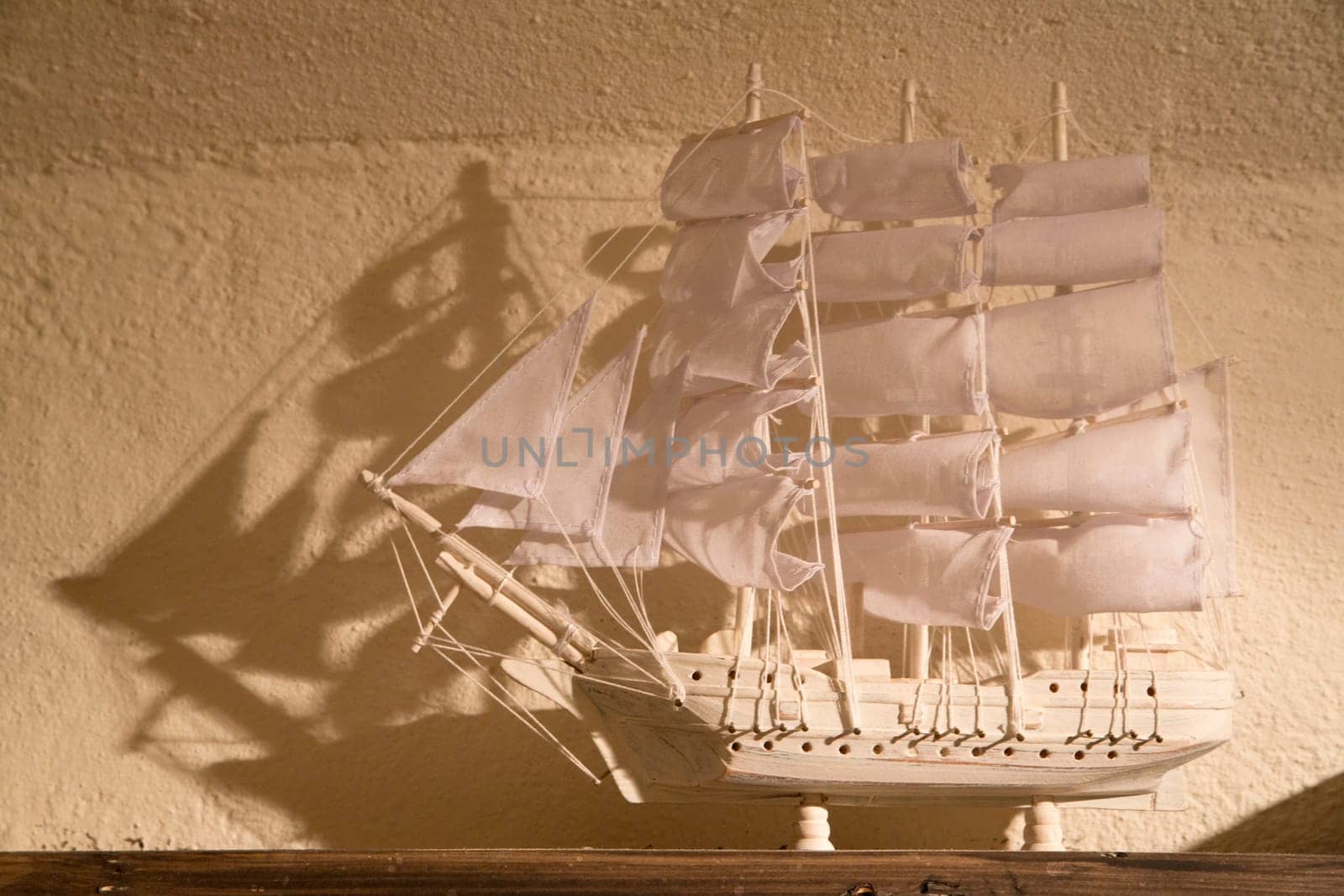 Small souvenir ship is white and on shelf