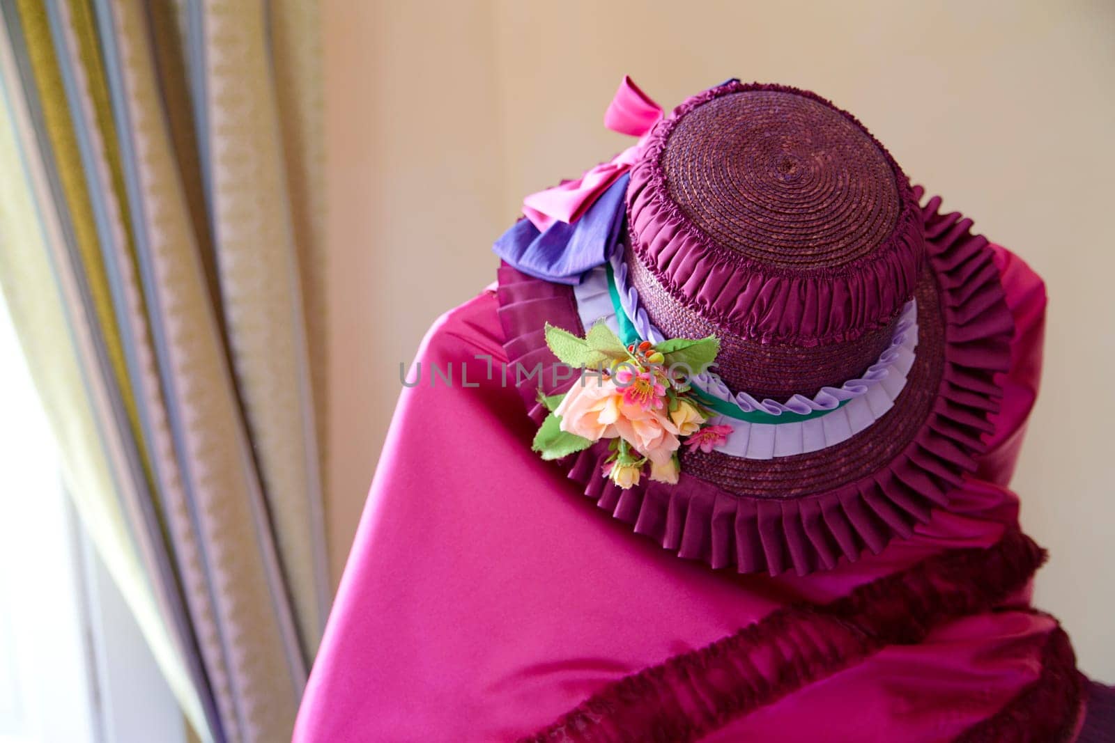 Interesting previous century pink dress and summer hat