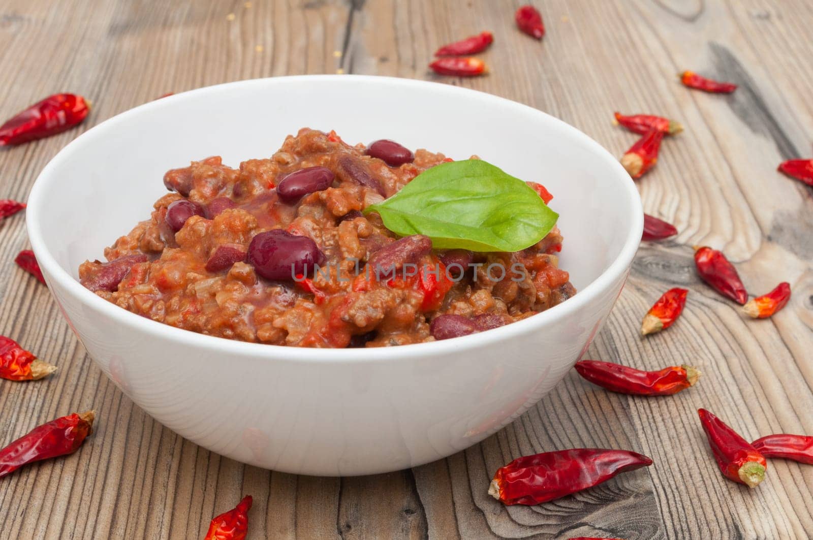 Chilli Con Carne in White Bowl and Red Chili Peppers