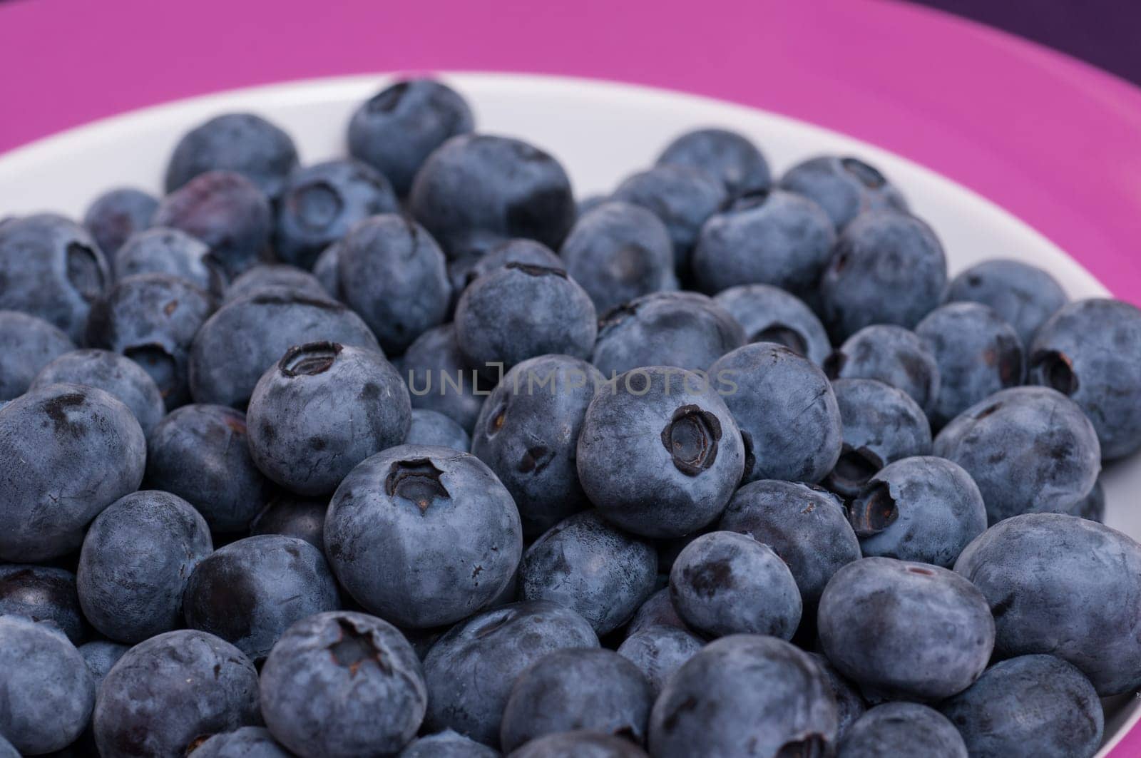 Blue blueberries on a plate as a close-up