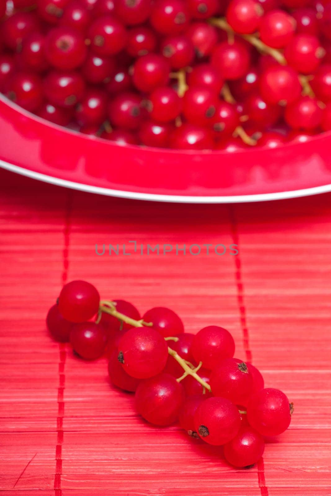 Red currants in a plate on placemat