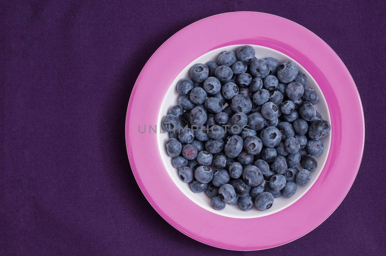 Blueberries on a plate and tablecloth