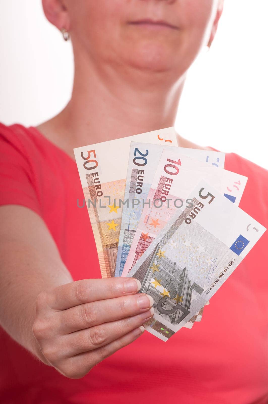 Woman holding several euro bills with her hand in front