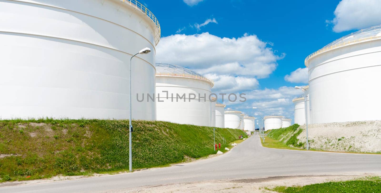 row of large white tanks for petrol and oil in the Amsterdam harbor