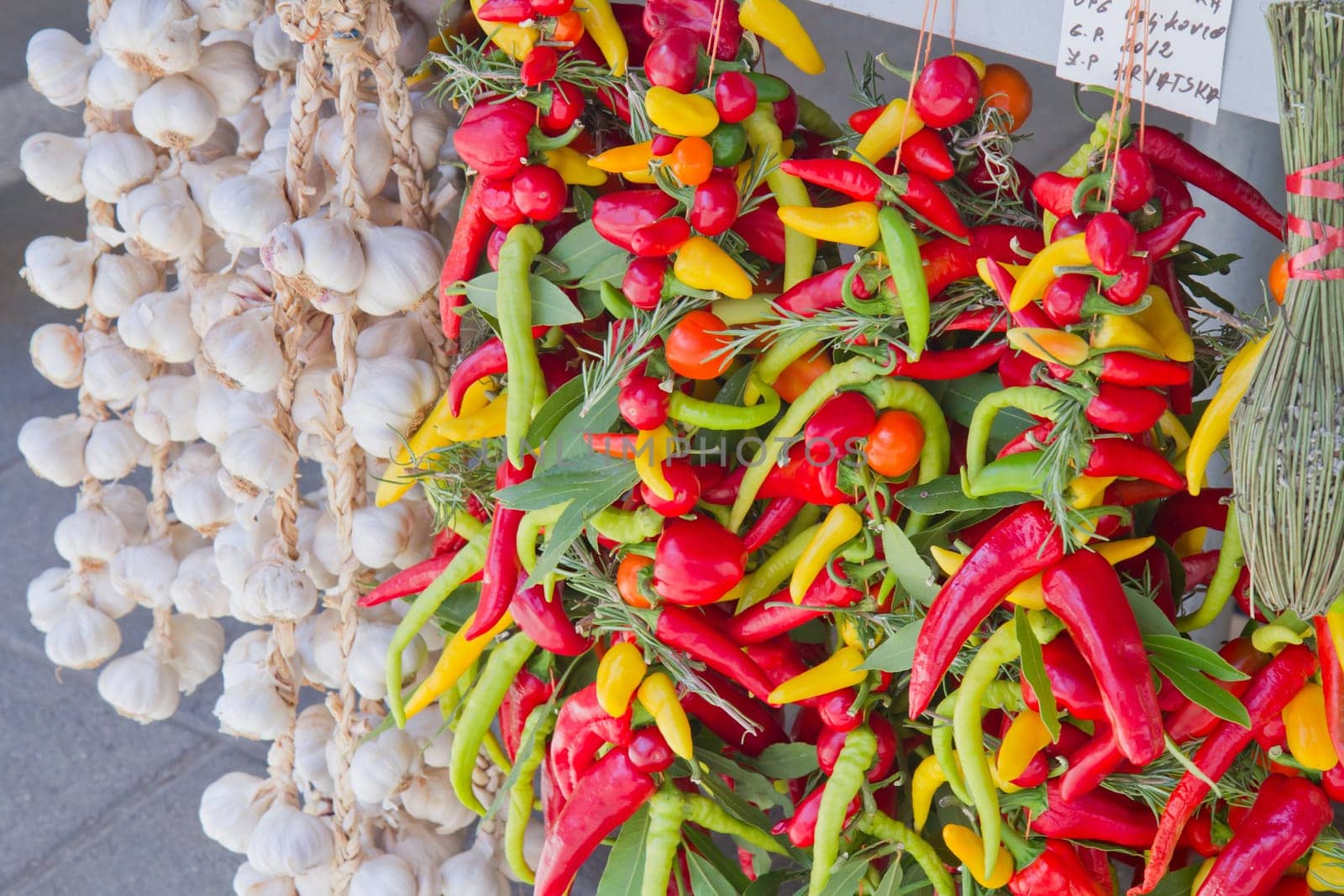 Organic garlics hanging and fresh chili  pepper in a market place