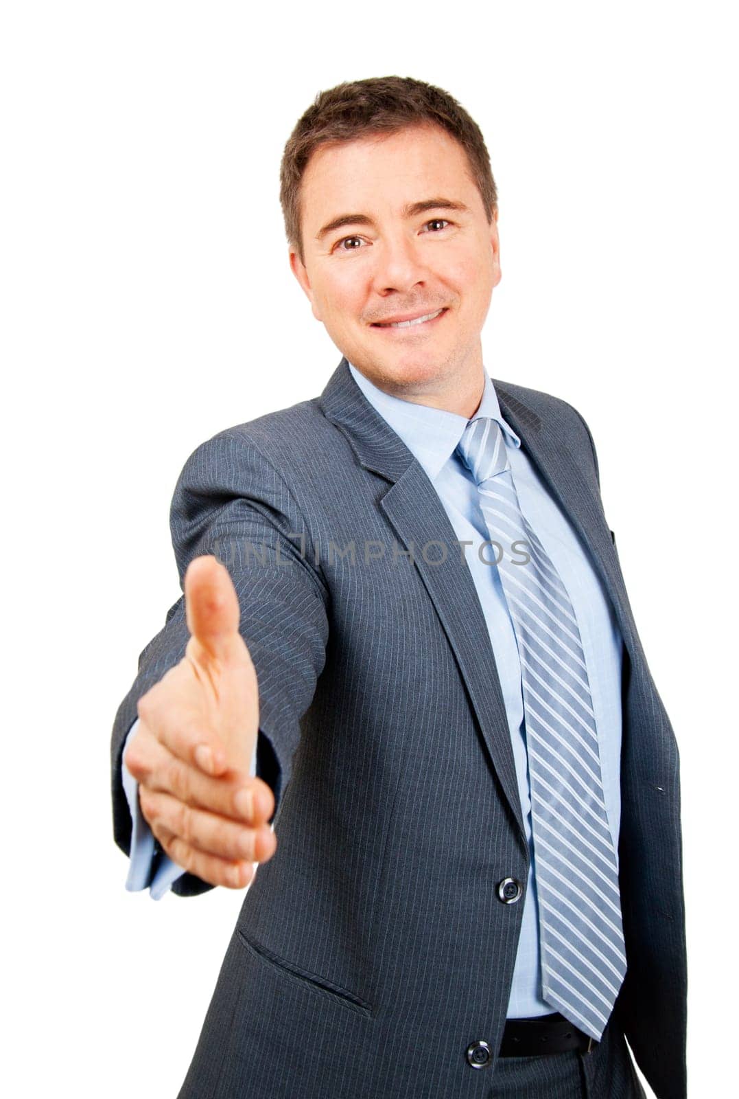Confident business man holding out hand in friendly hand shake gesture on isolated background