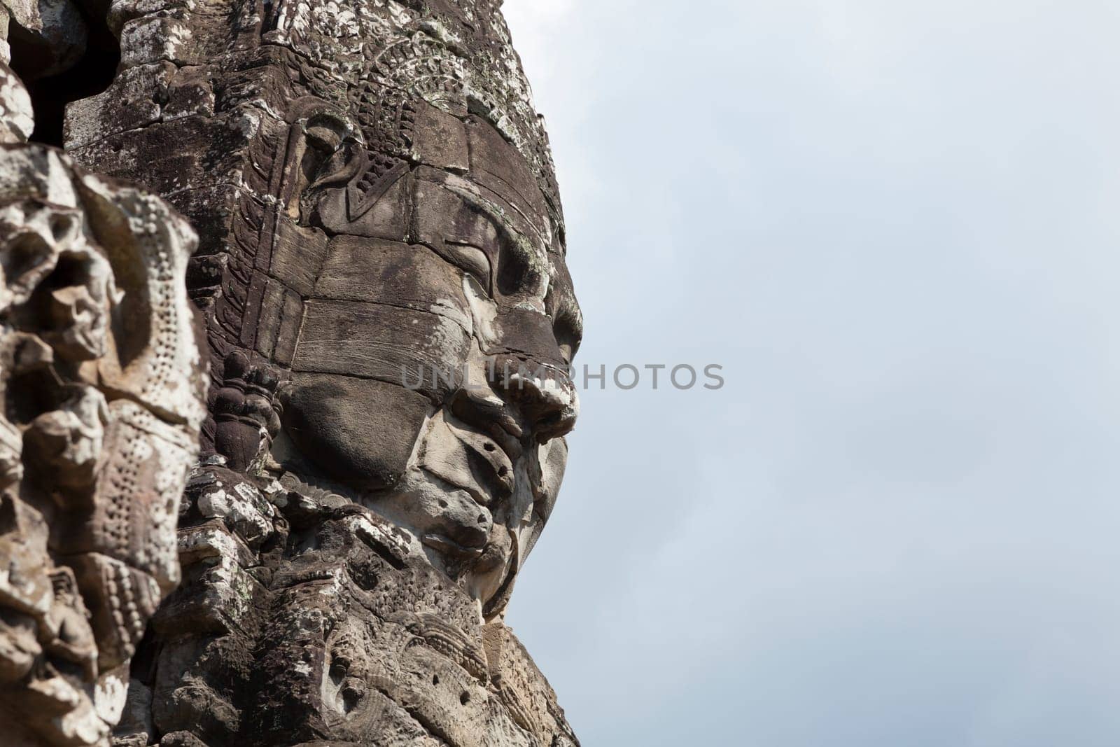 Massive stone faces decorating towers of Bayon temple in Angkor Thom, Cambodia