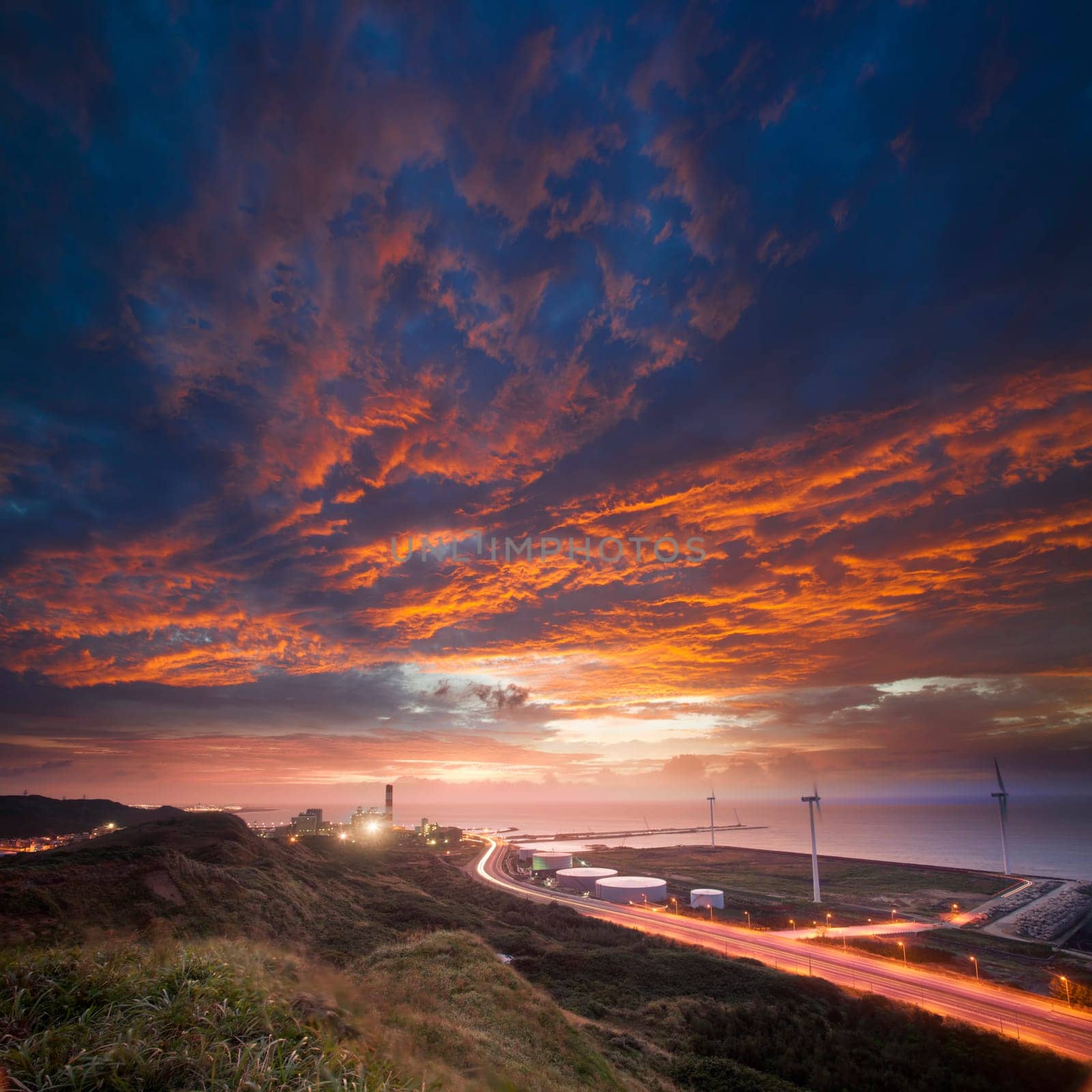 A road and windmills during sunset, made with a wide angle lens