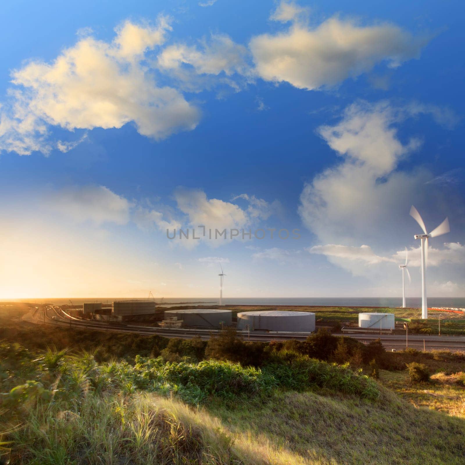 A road and windmills during sunset, made with a wide angle lens