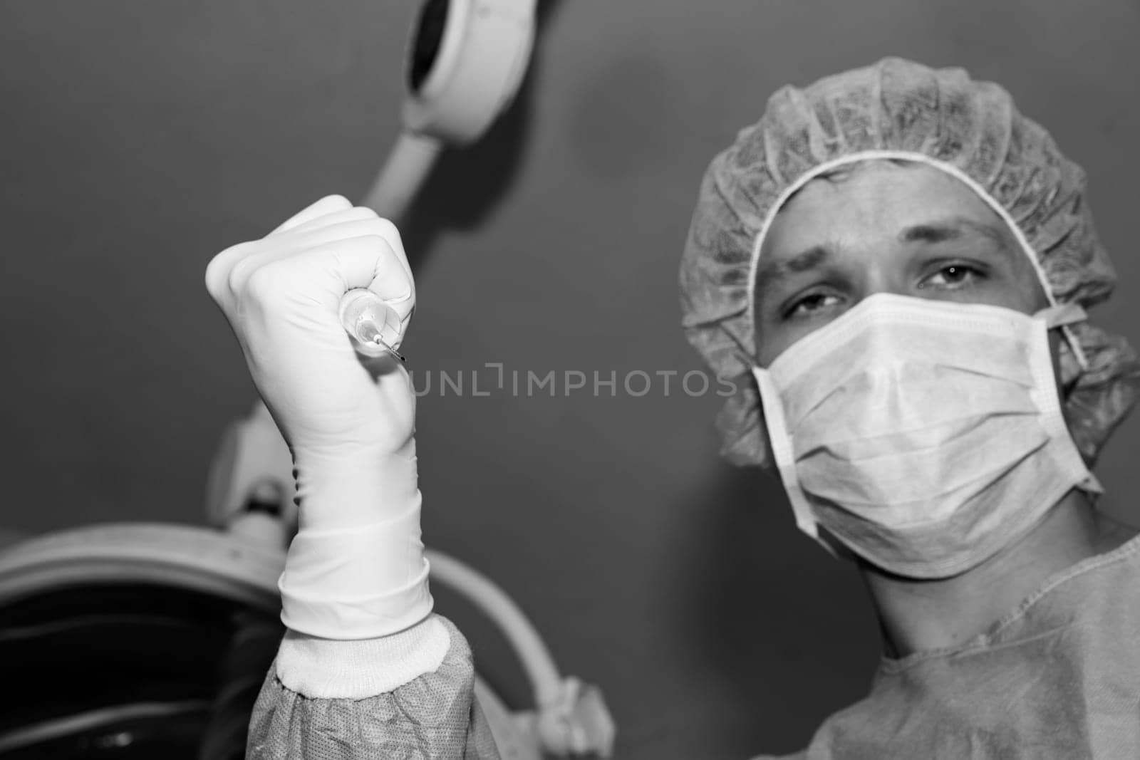 Shaded surgeon making injection before coming difficult surgery