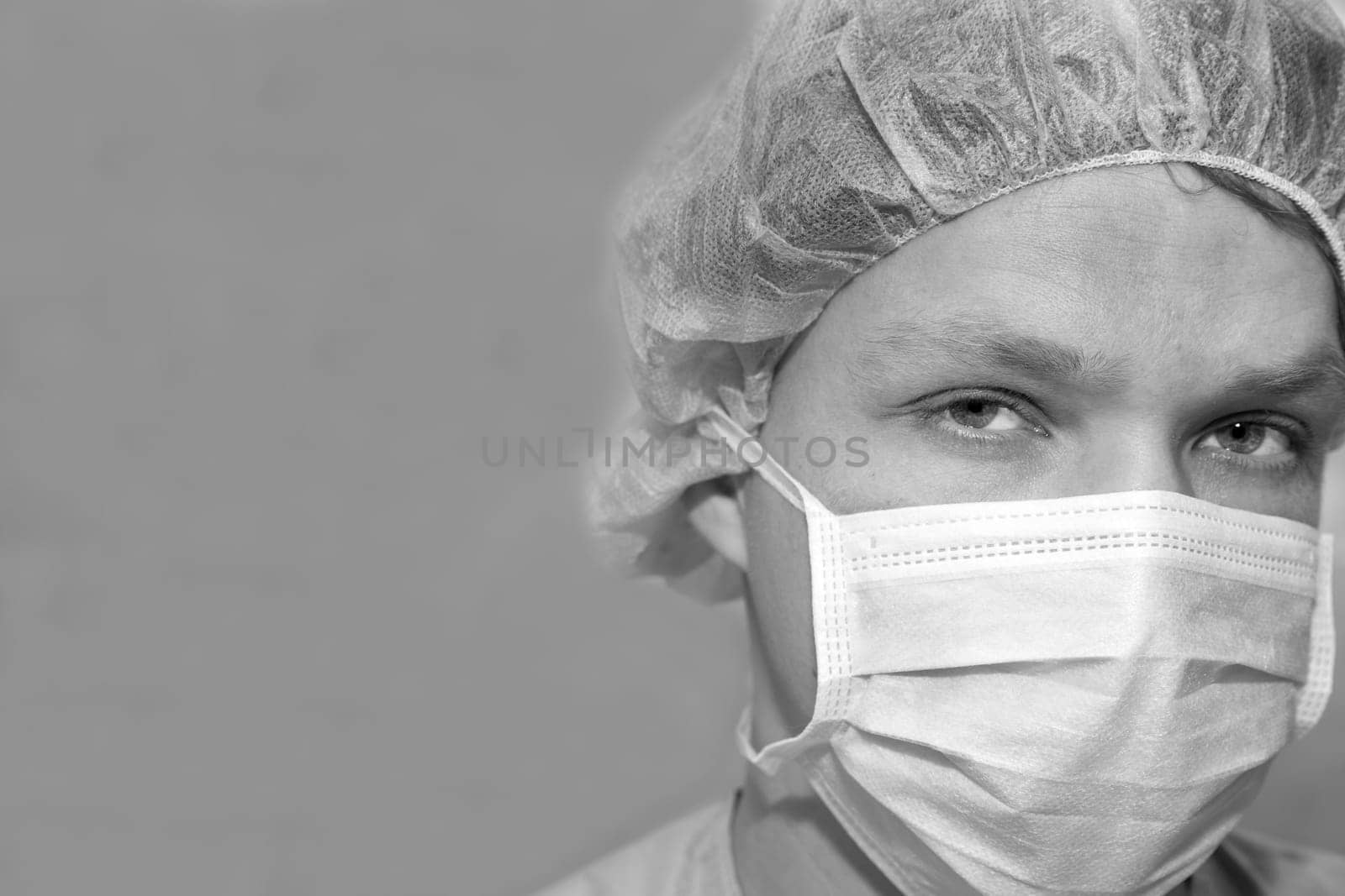 Shaded surgeon zoomed face before coming difficult surgery