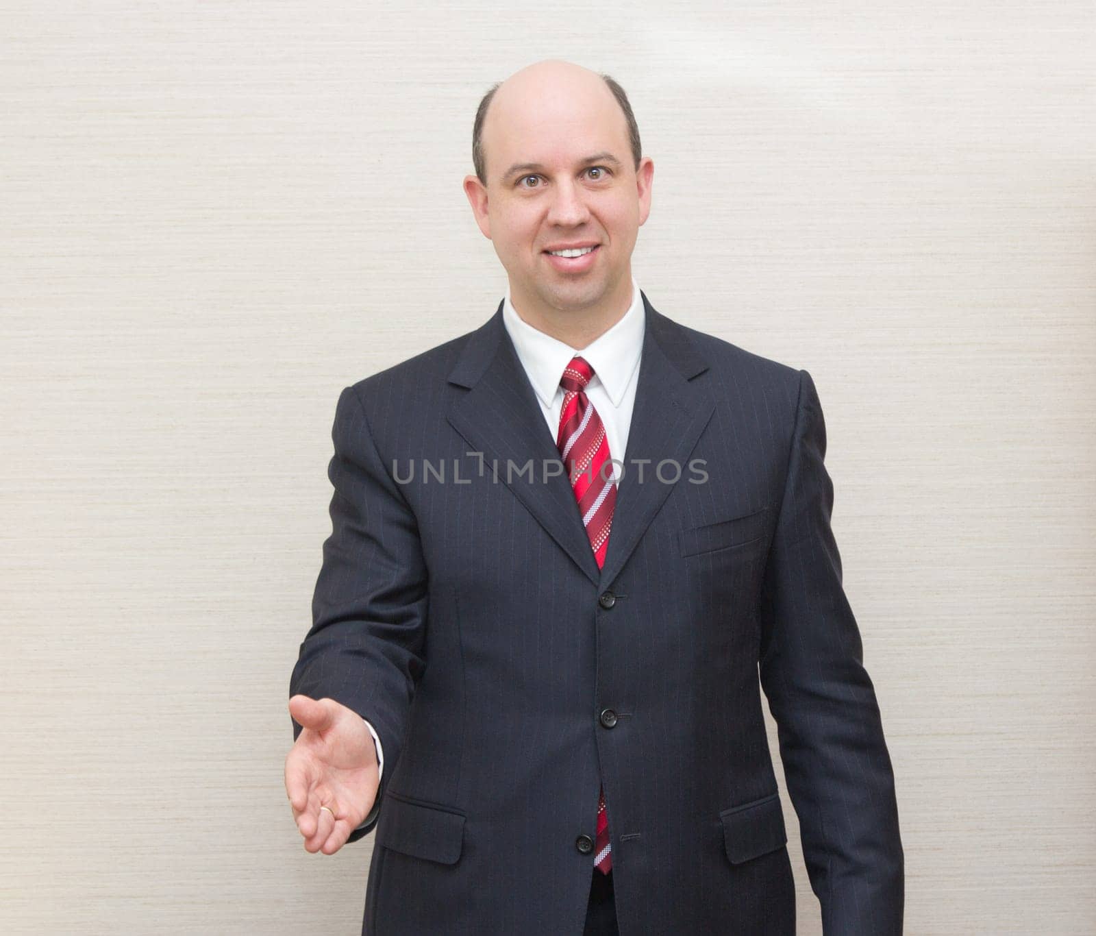 Business man offering a handshake.