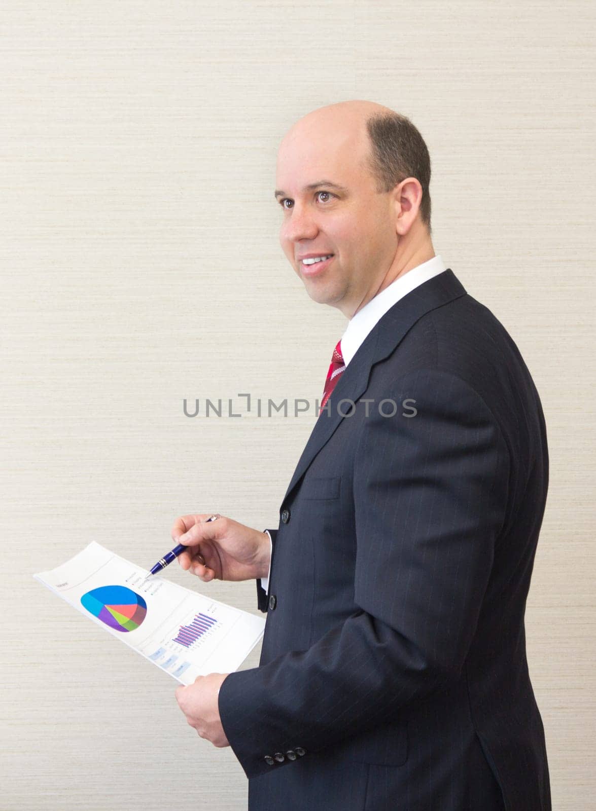 Smiling business man with document.