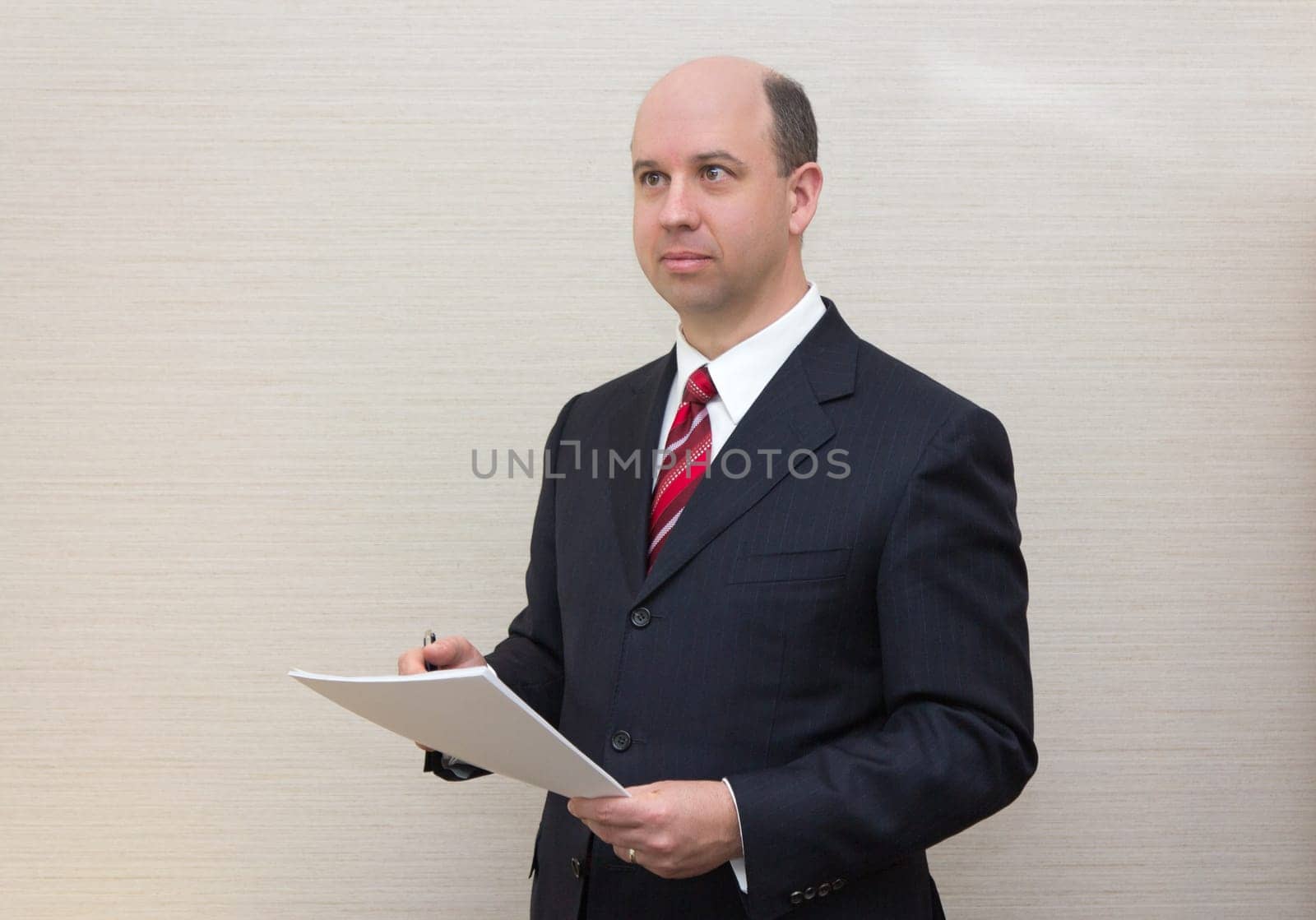 Business man holding a document.