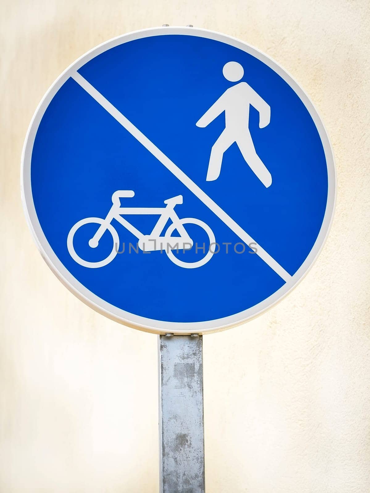 Bicycle and pedestrian lane road sign on pole post, large blue round isolated bike cycling and walking walkway footpath route traffic roadside signage