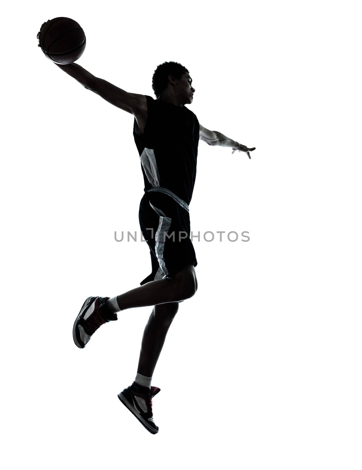 one young man basketball player silhouette in studio isolated on white background