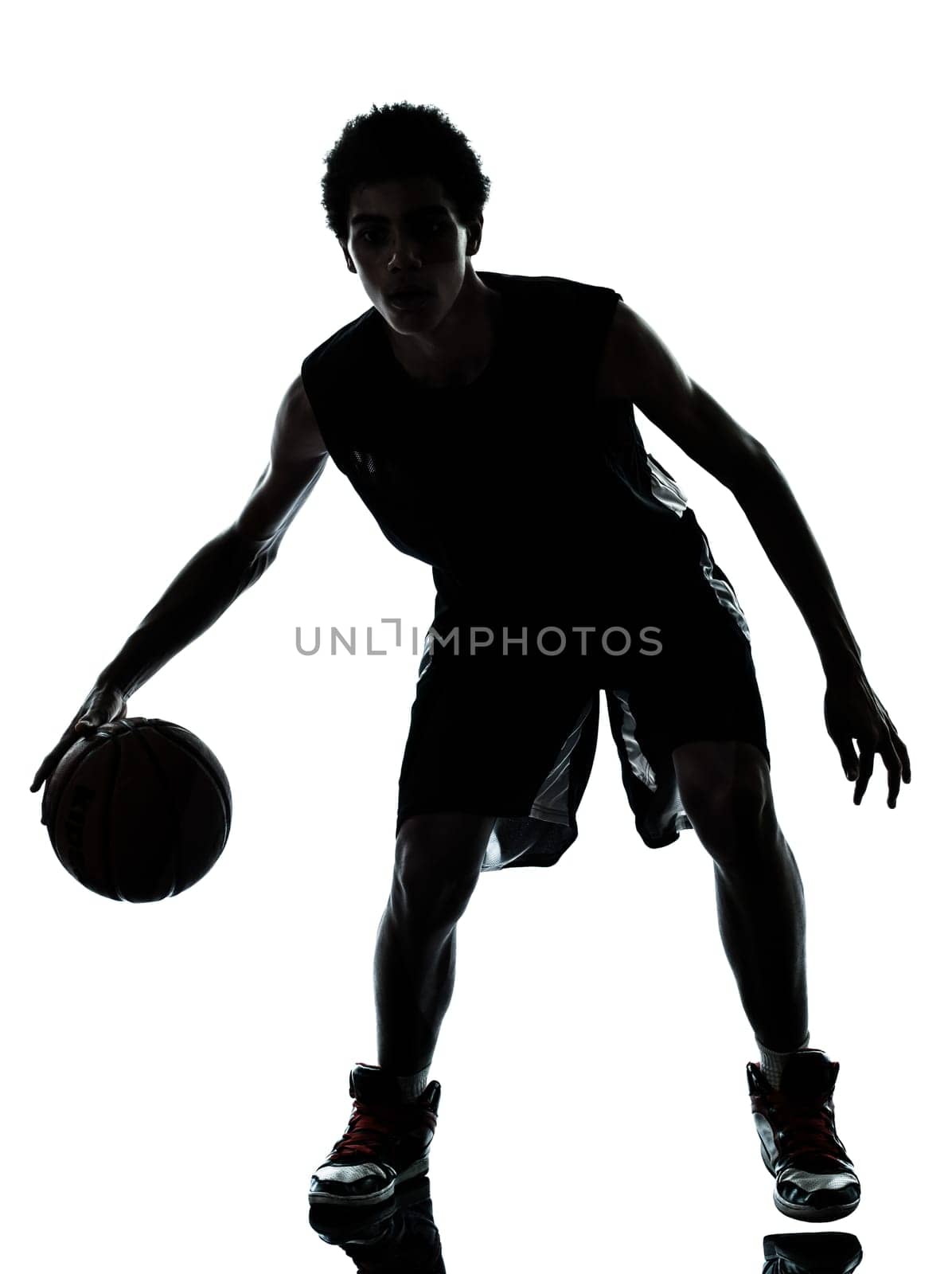 one young man basketball player silhouette in studio isolated on white background