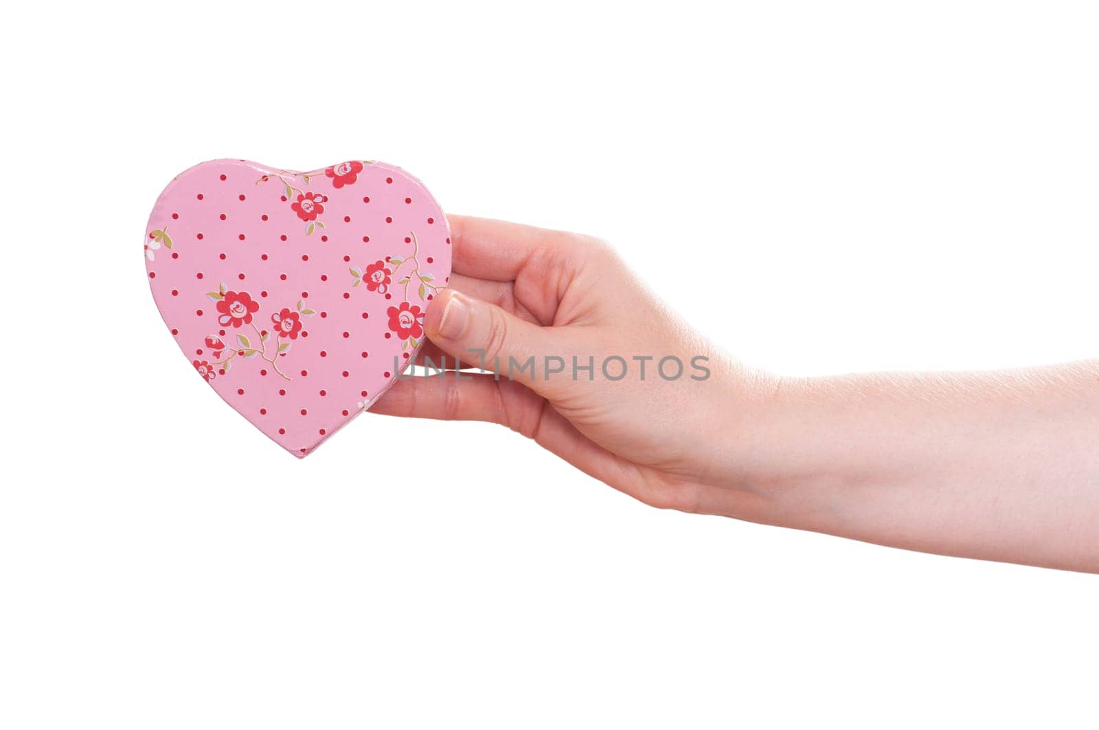 Female hand holding a pink heart with flowers facing forward