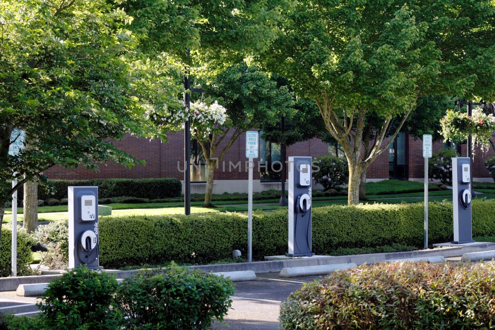 BEAVERTON, OREGON - MAY 25: Three electric vehicle charging stations located across from the city library on May 25, 2012 in Beaverton, Oregon. Energy is partially supplied by photovoltaic panels located nearby.
