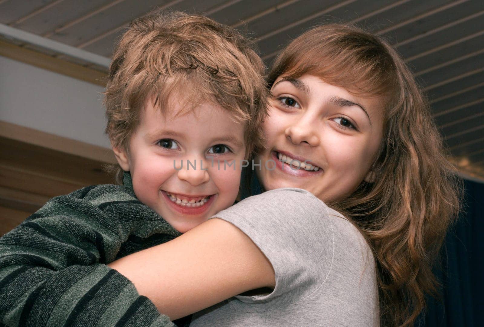 Girl and boy smile and are embraced
