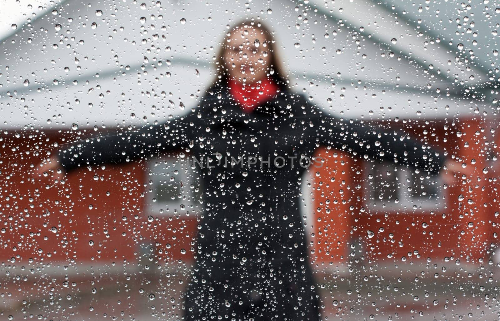 Beautiful girl with red scarf and umbrella for glass with drop of water