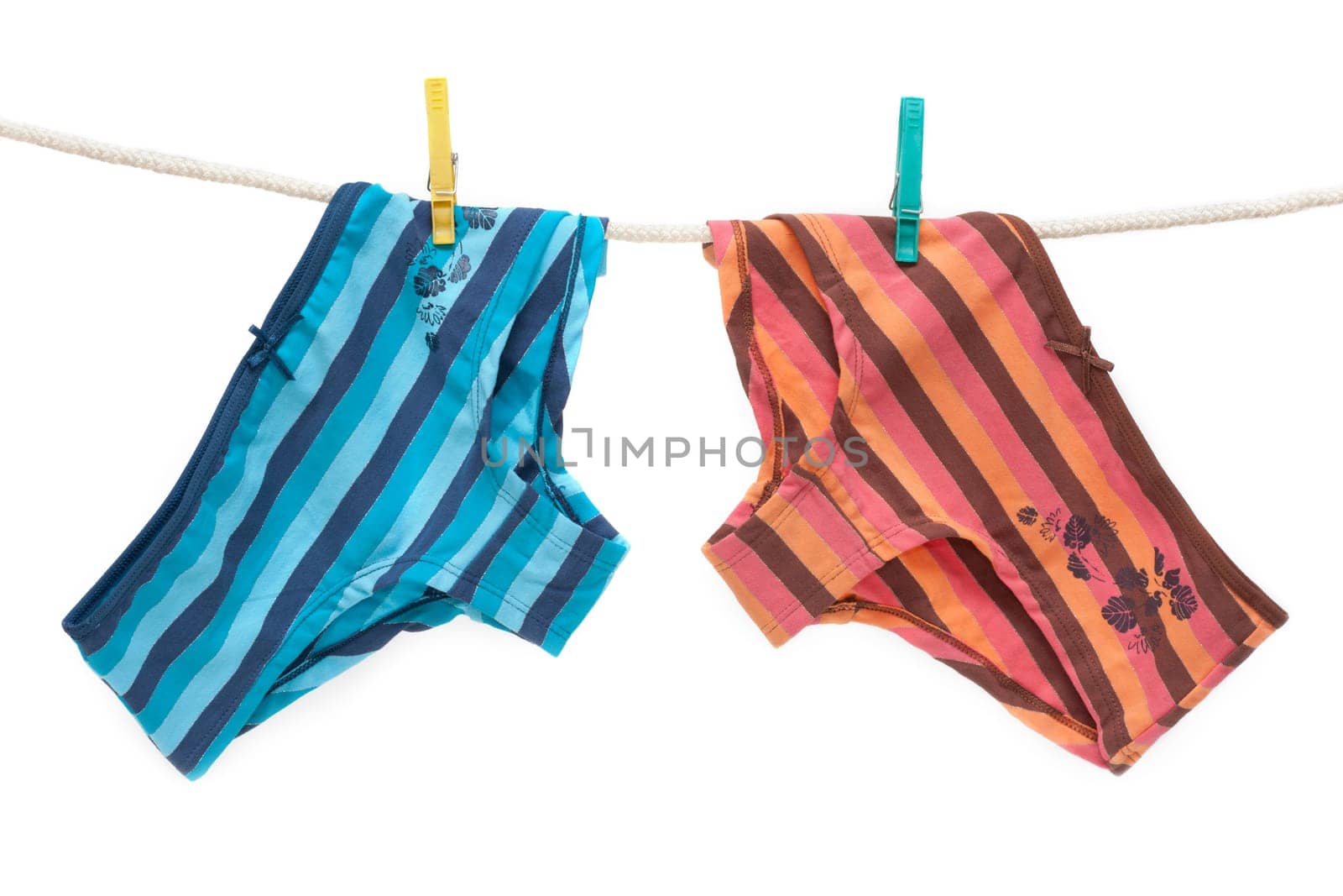 Feminine colour panties hung on linen rope, isolat