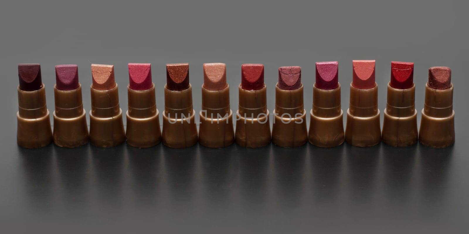 Small tubeses lipstick on dark gray background