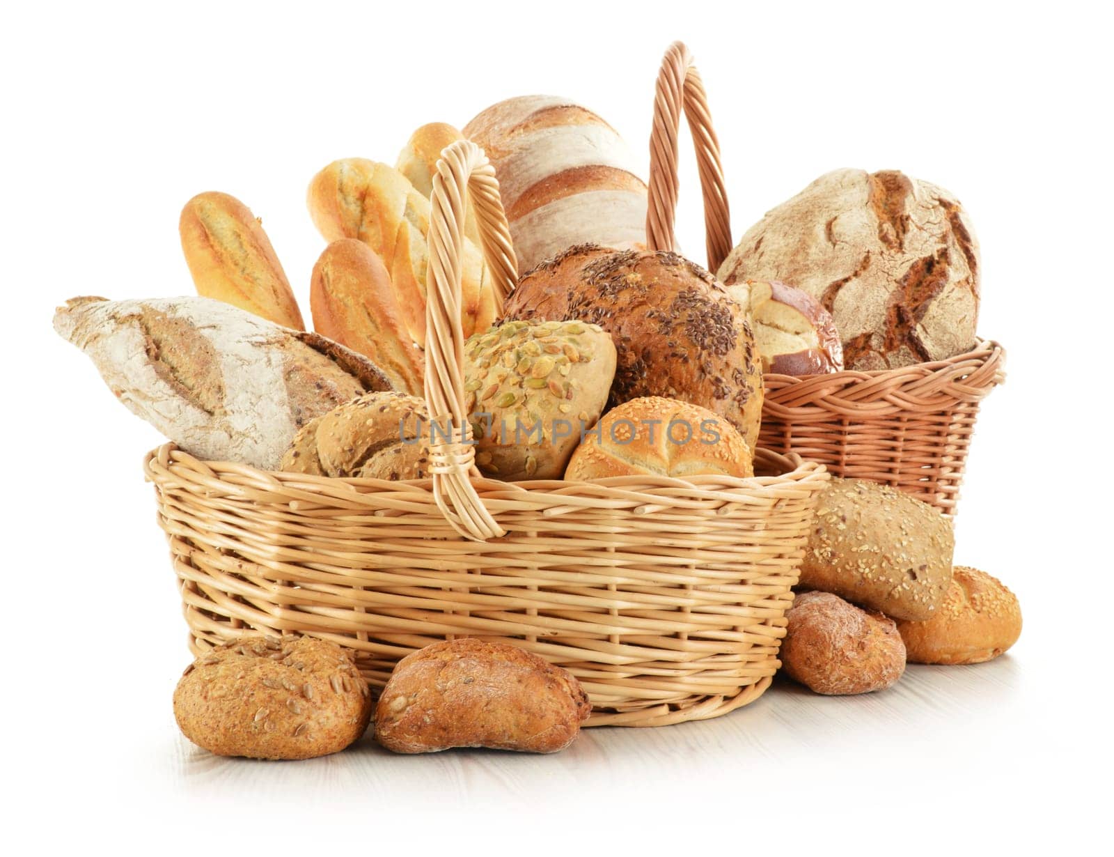 Composition with bread and rolls in wicker basket isolated on white