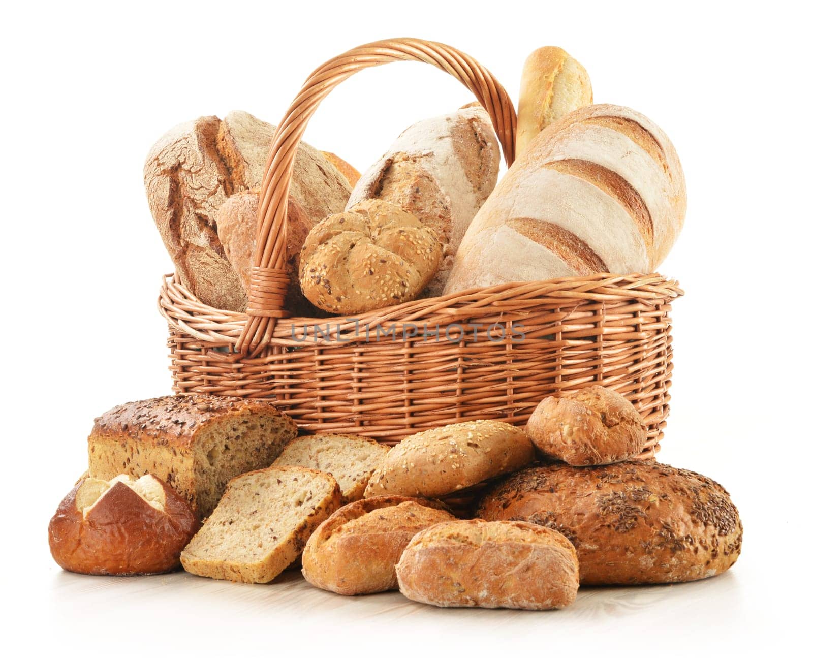 Composition with bread and rolls in wicker basket isolated on white