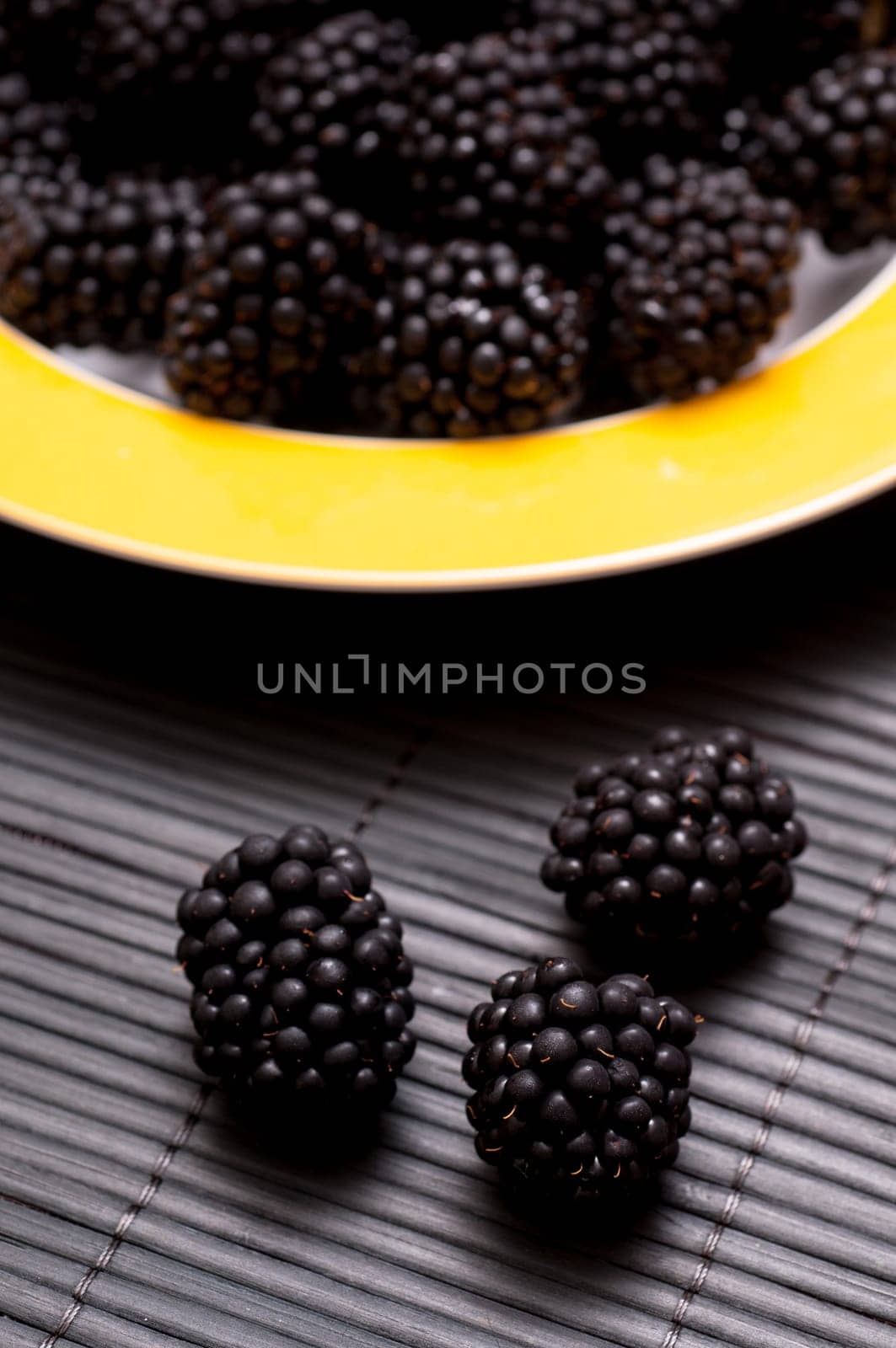 Close-up of black hotberries on dark background