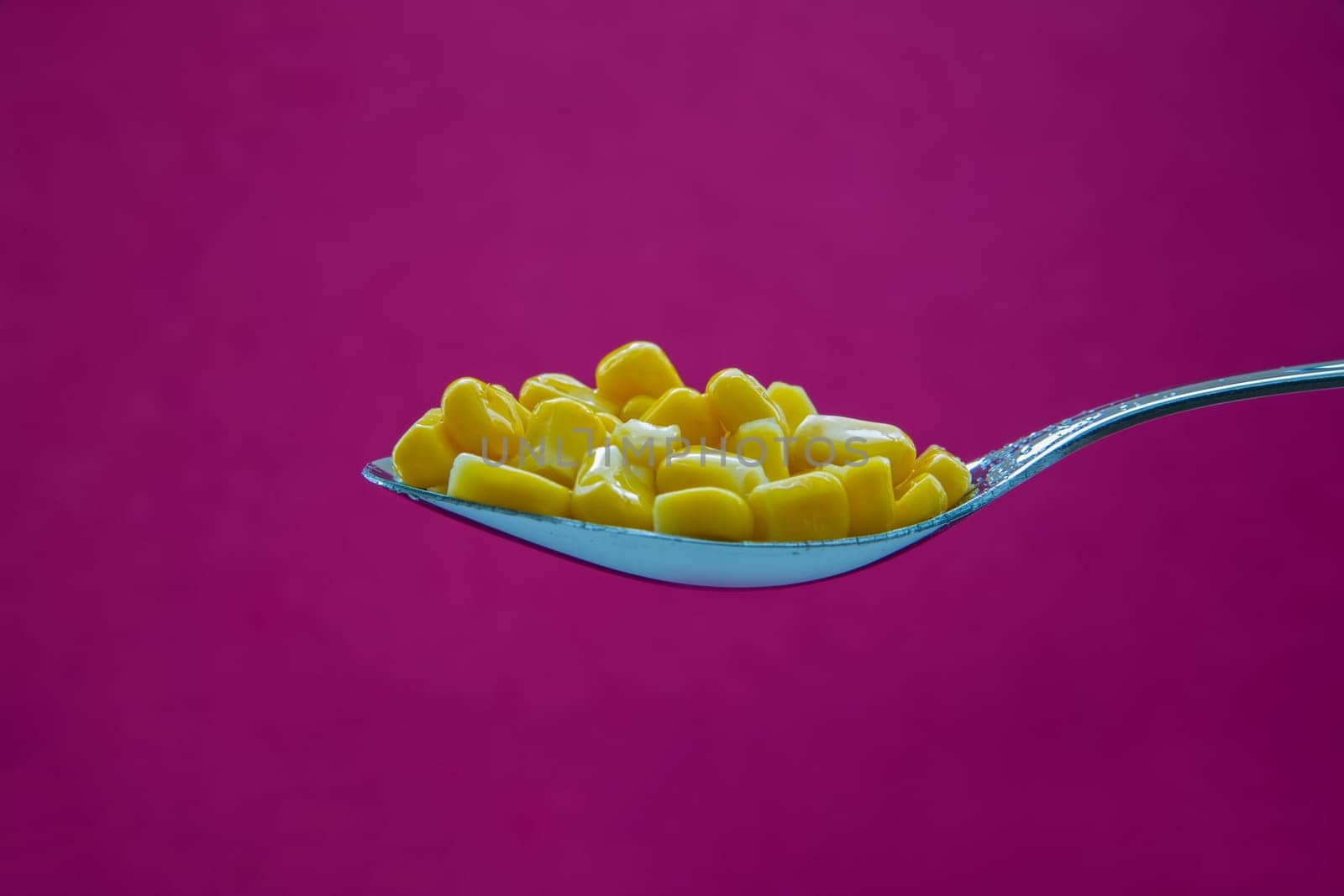Yellow corn is ready for eating on spoon