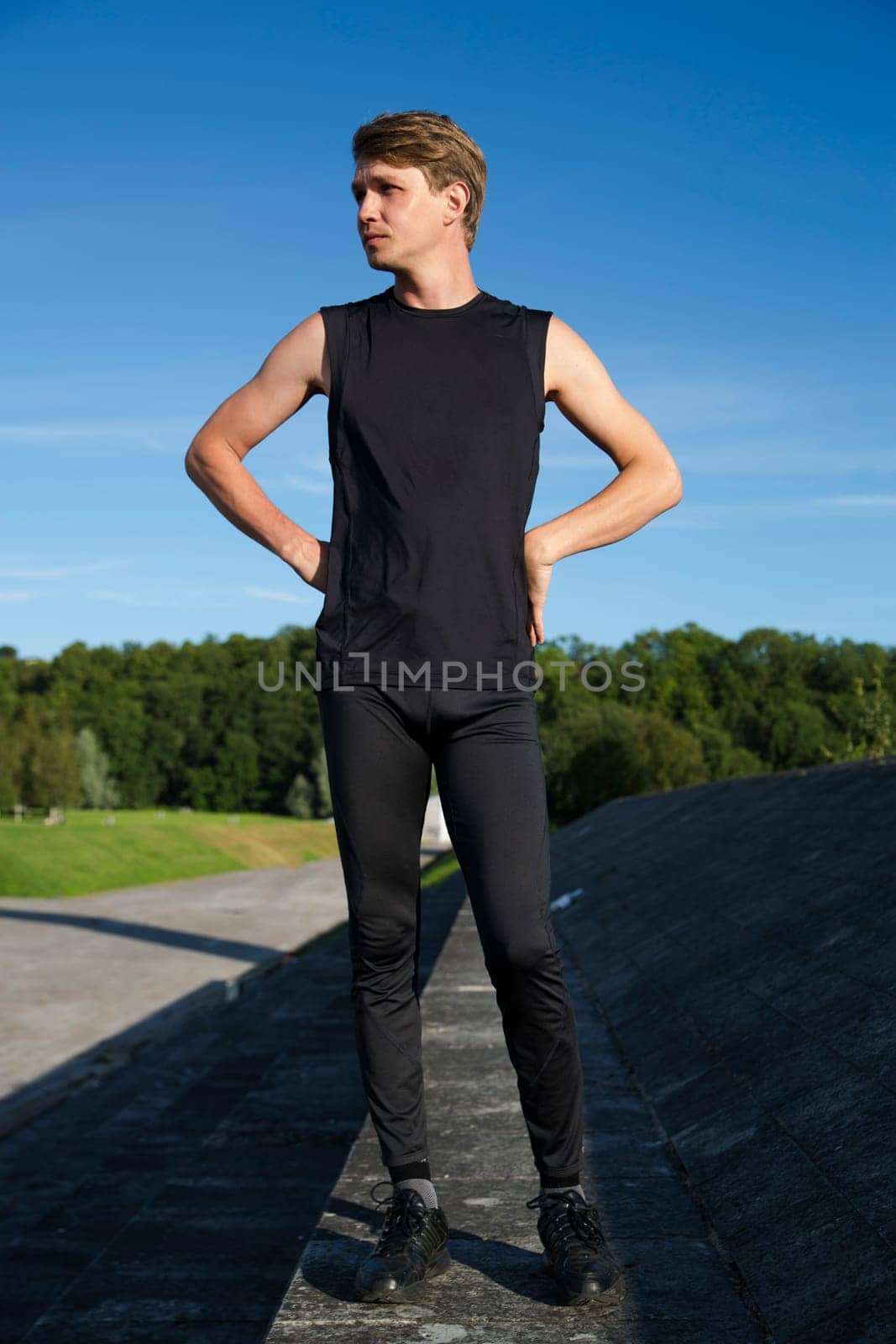 Sportsman is standing on some kind concrete foundation