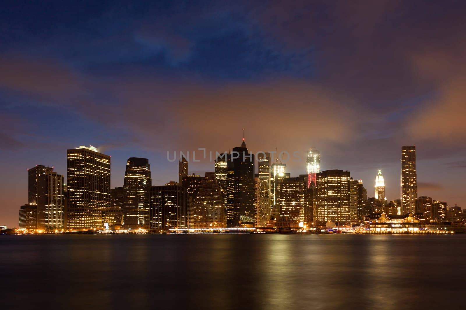 Manhattan skyline by night from Brooklyn bridge park - USA