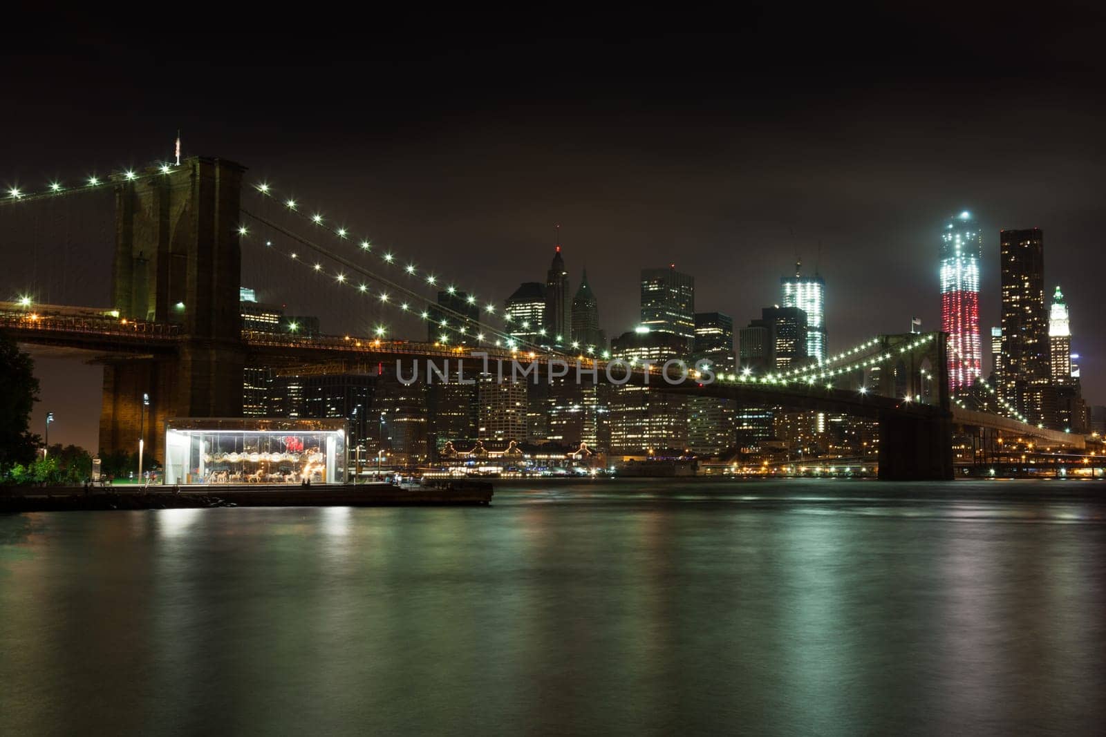Manhattan skyline by night from Brooklyn bridge park - USA