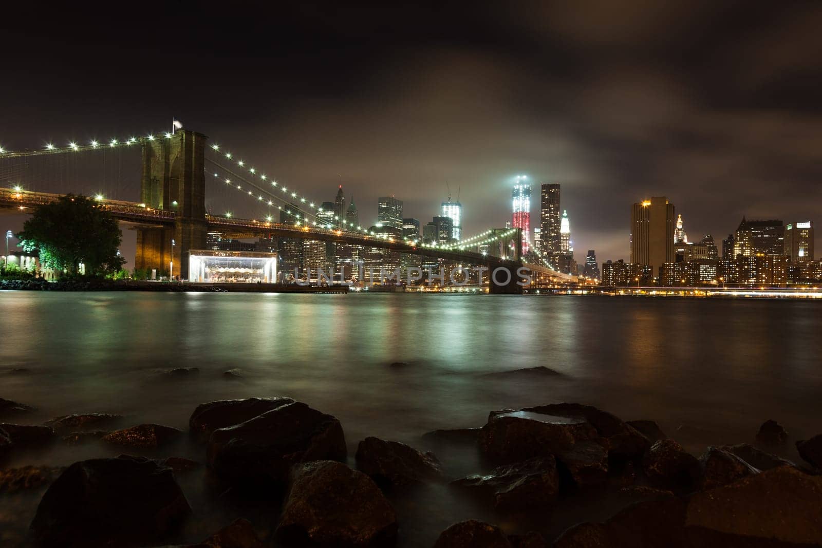 Manhattan skyline by night from Brooklyn bridge park - USA