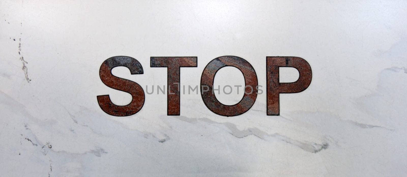 Inscription stop in aeroport on light marble