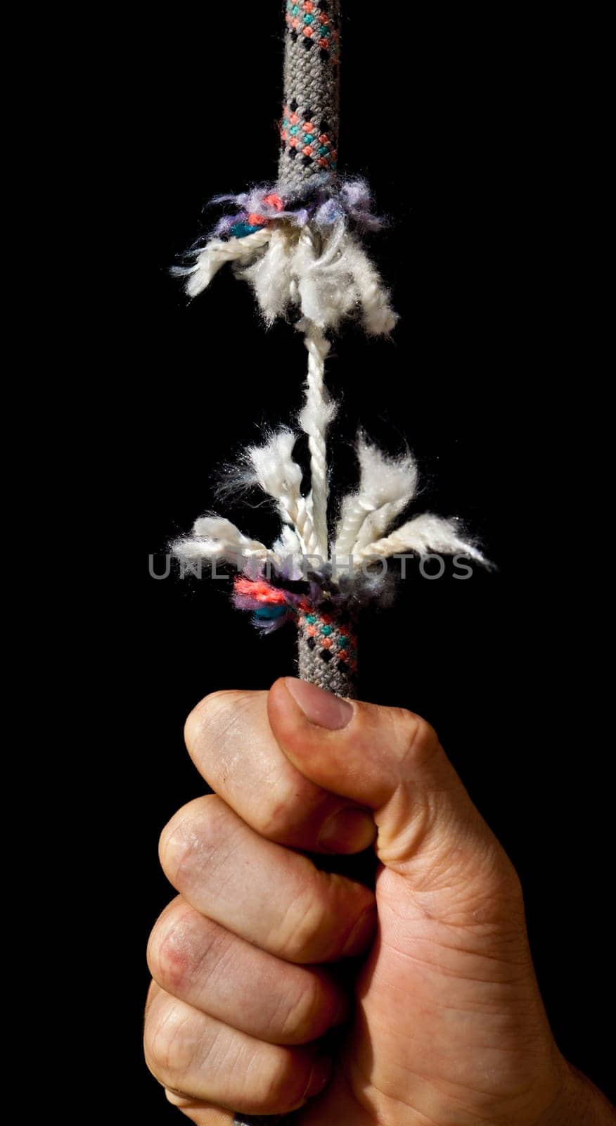 A rope is breaking on a black background