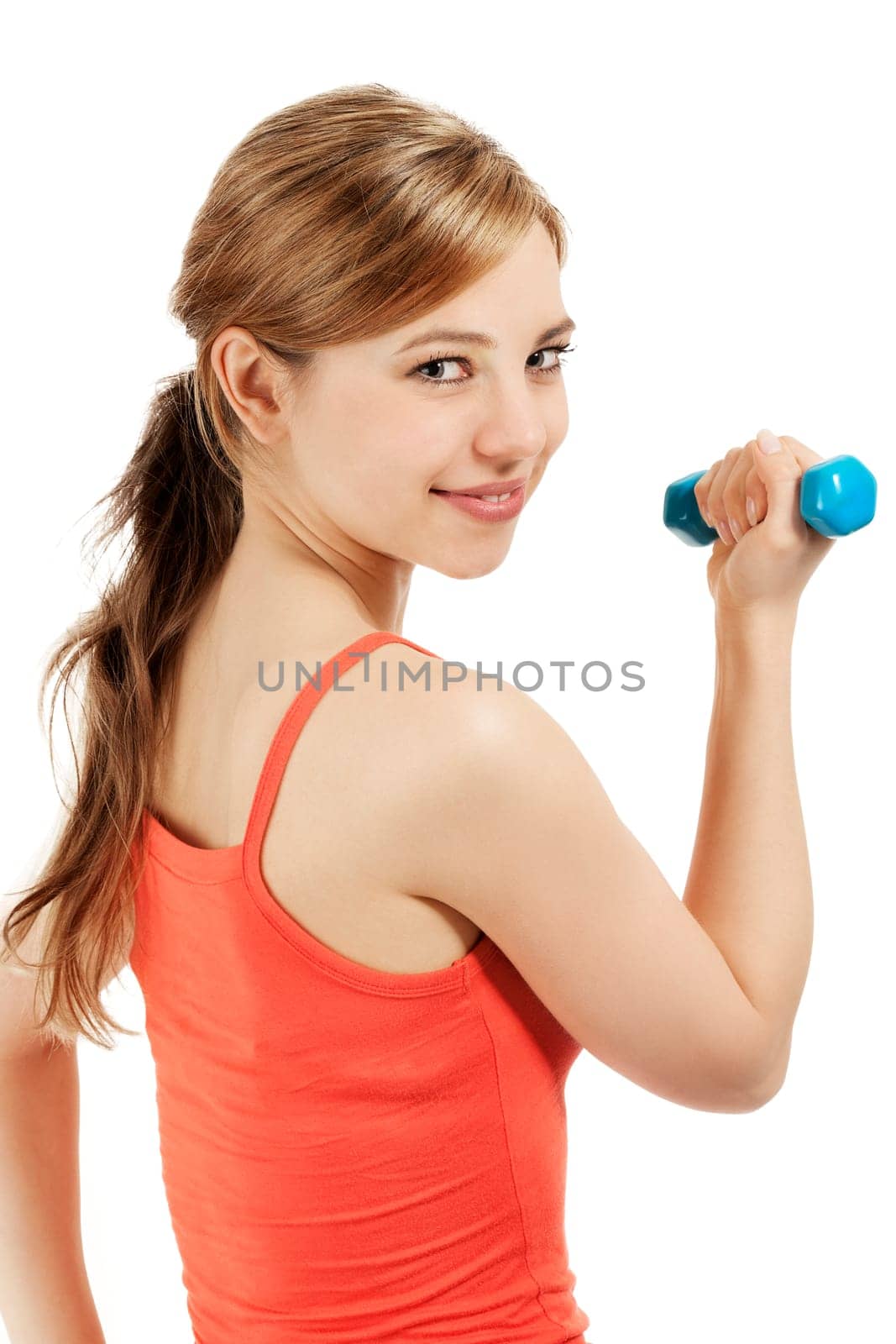 Pretty sportswoman with fitness dumbbell looking over shoulder against white background