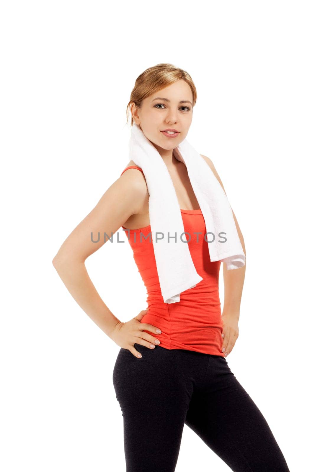 Portrait of happy sportswoman with towel against white background