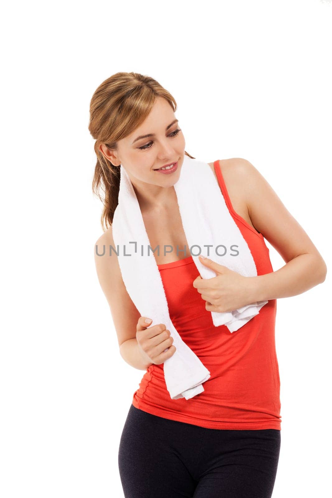 Young sportswoman with towel looking to the side against white background