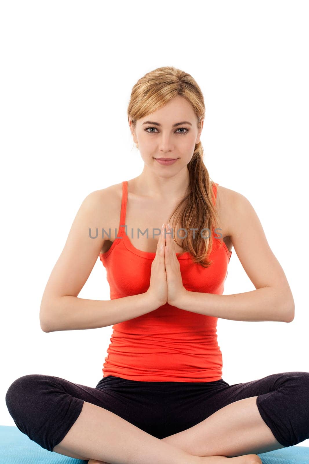 Young sitting woman doing yoga exercises in front of white background