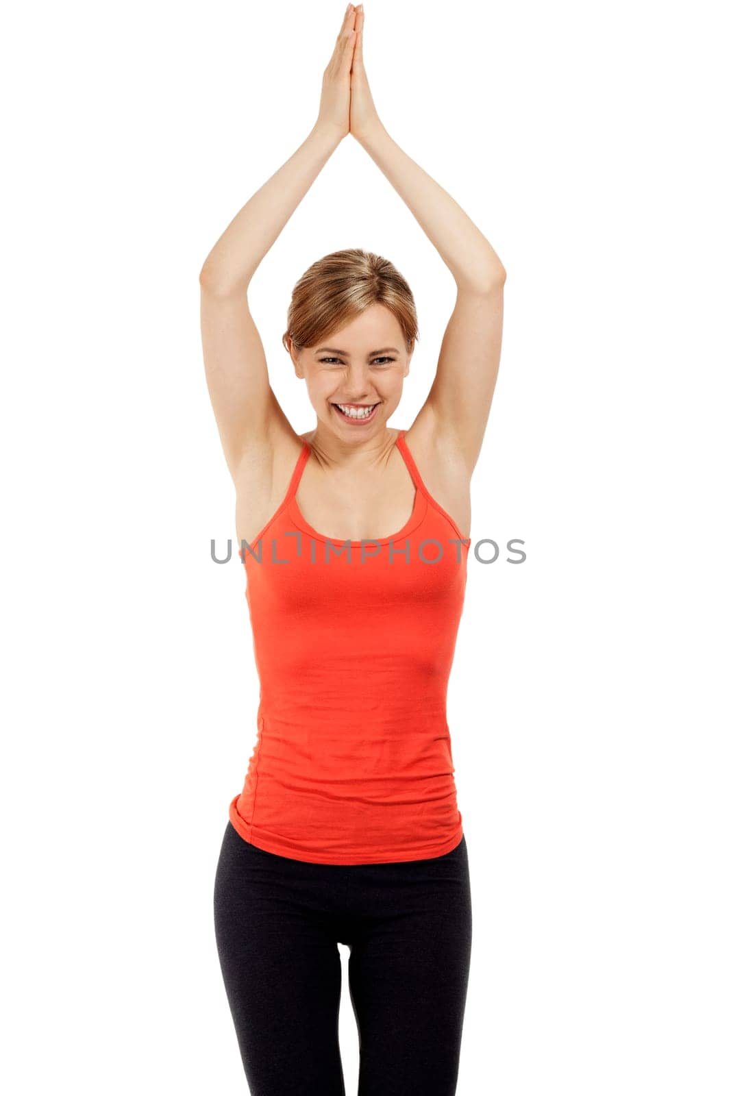 Young sportswoman doing yoga exercises in front of white background