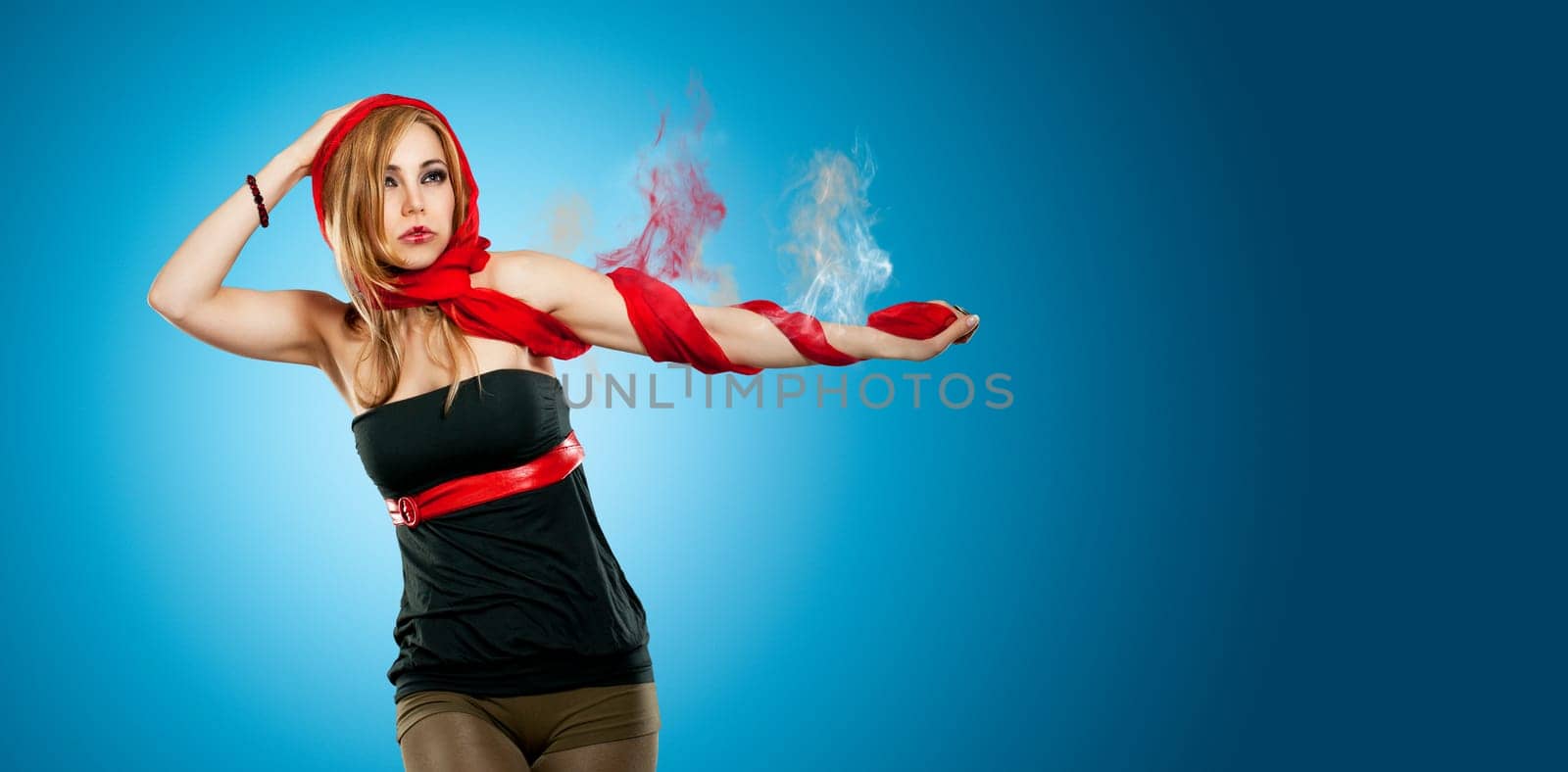 Beautiful young woman with smoking arm against blue background