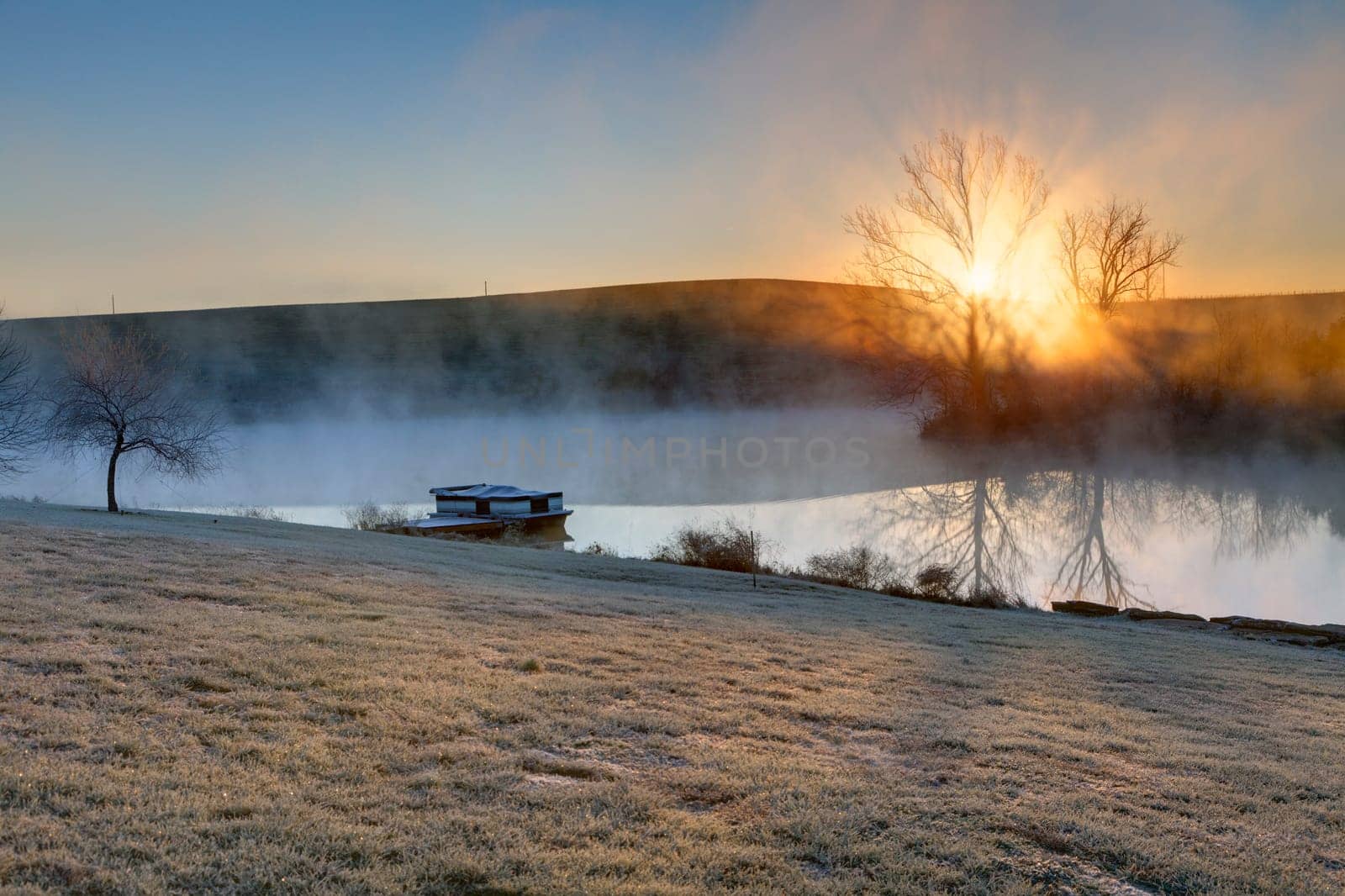 Sunrise on a frosty morning over a small lake in central Kentucky