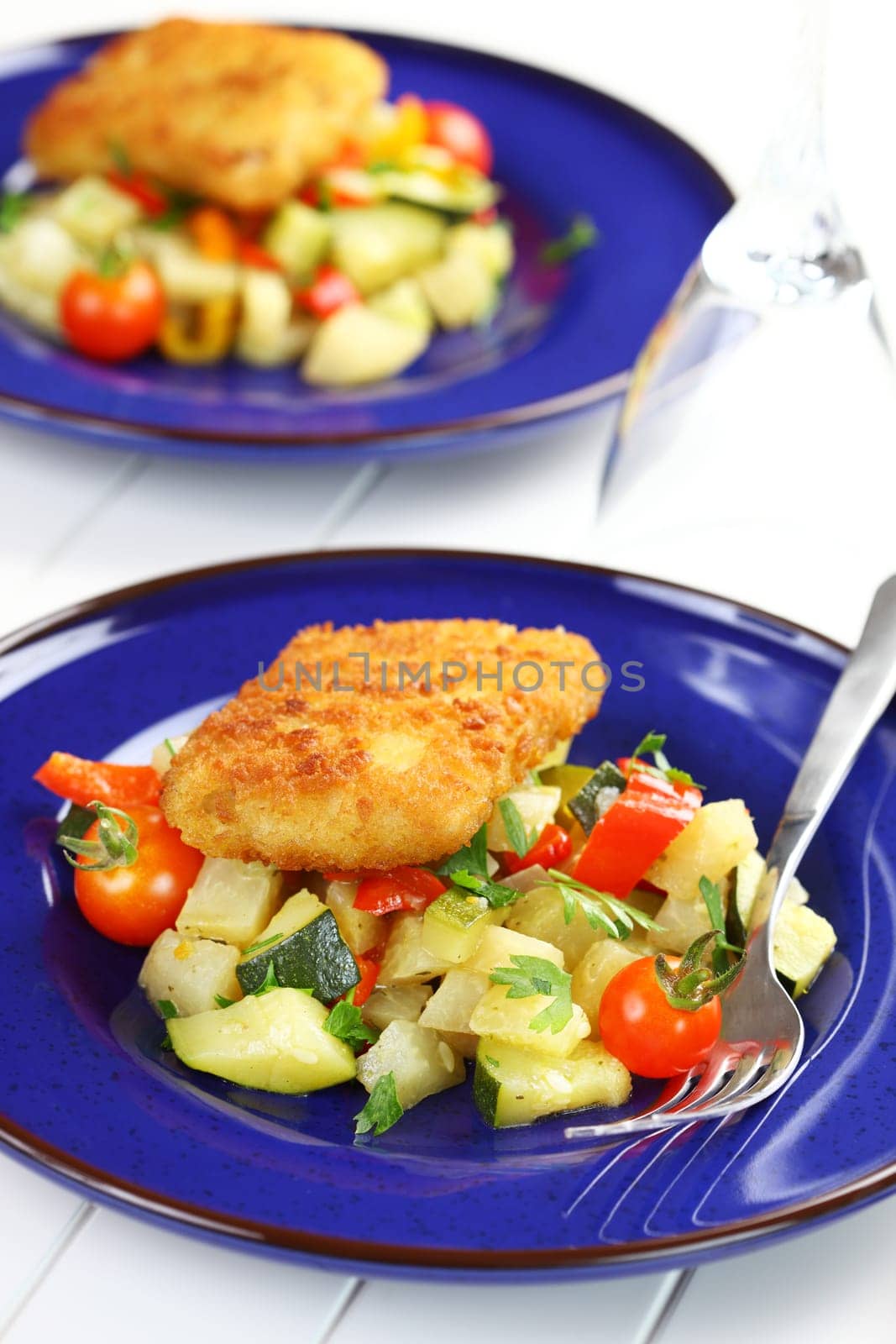 Delicious fried fish fillet on vegetables