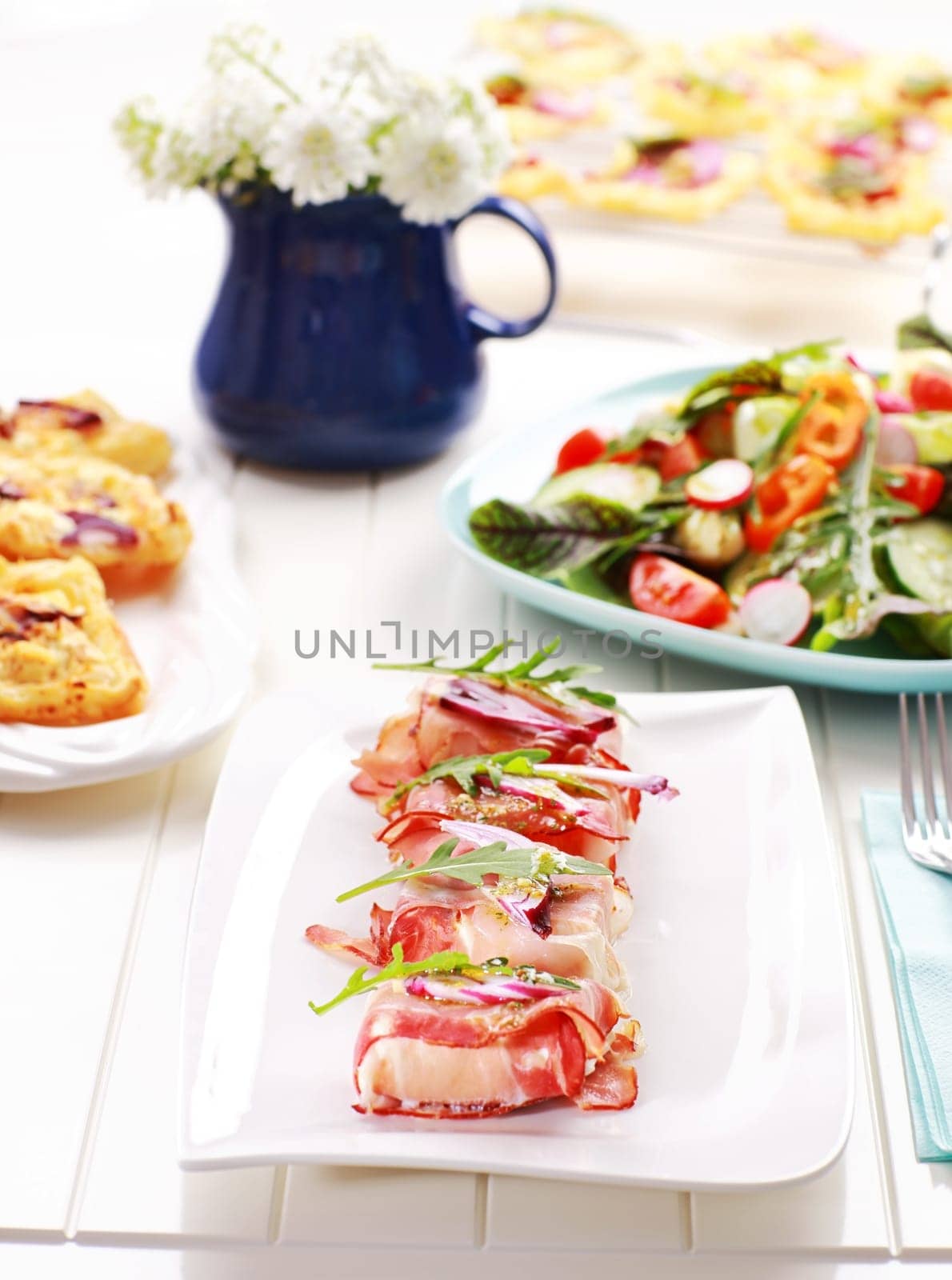 Prosciutto rolls filled with cheese and arugula