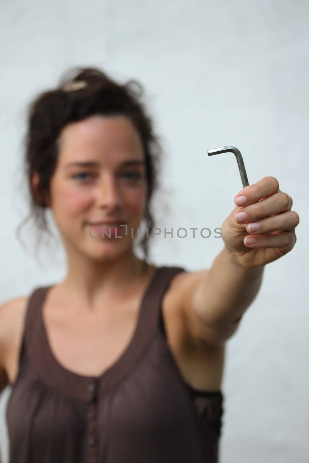 young woman holding an allen key