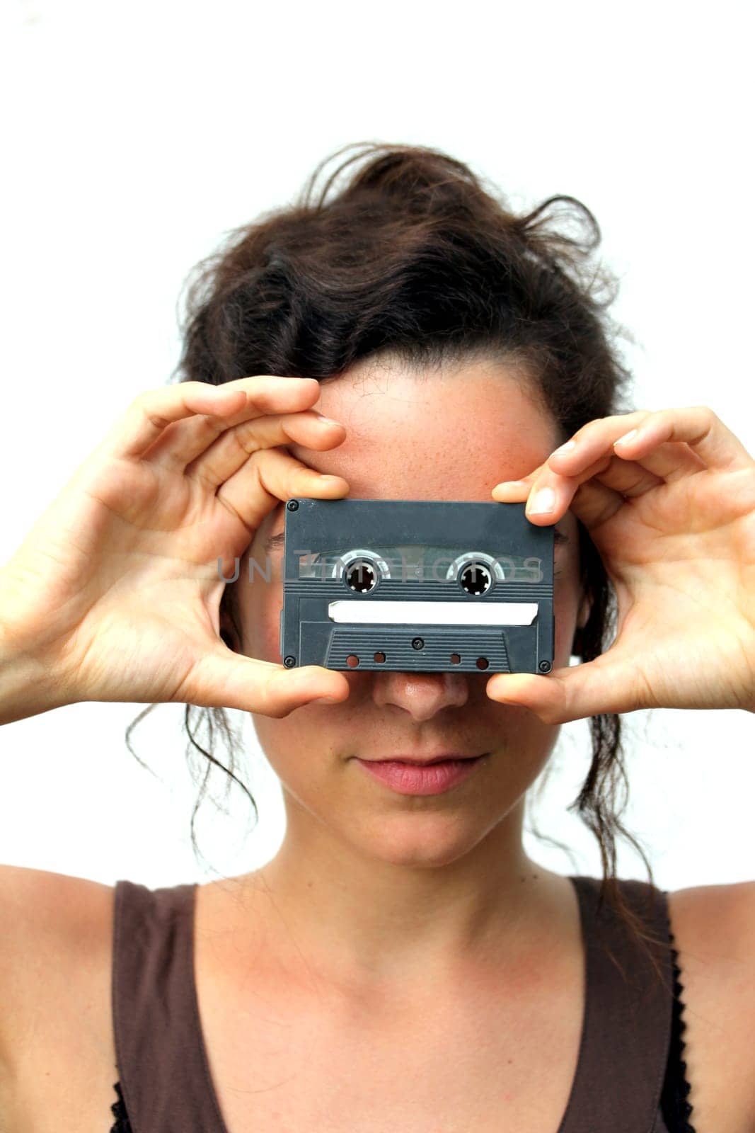 young woman holding a plain cassette