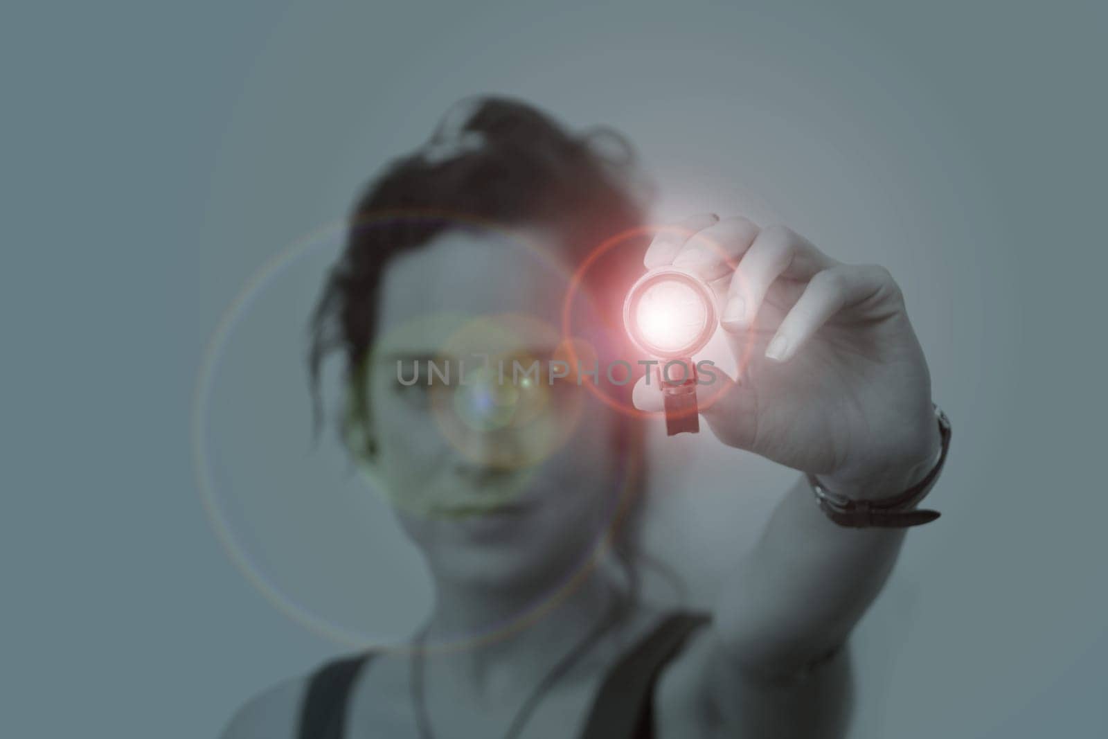 young woman holding a led flashlight at night
